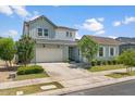 Charming two-story home with a three-car garage, lush lawn, and inviting curb appeal at 10144 E Toledo Ave, Mesa, AZ 85212