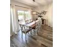 Cozy dining room with stylish chairs, decorative lighting, and sliding door access at 10229 N 12Th Ct # 1, Phoenix, AZ 85020