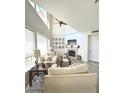 Open concept living room featuring high ceilings, fireplace, and neutral decor at 10229 N 12Th Ct # 1, Phoenix, AZ 85020