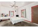 Bedroom featuring a ceiling fan, large windows, and neutral carpeting at 1029 E Mckinley St, Phoenix, AZ 85006