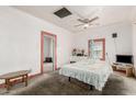 Bright bedroom with a ceiling fan, large windows, and carpeted floors at 1029 E Mckinley St, Phoenix, AZ 85006