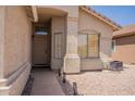 Home featuring a covered front porch, desert landscaping and a light-colored exterior at 10346 E Desert Dawn Dr, Gold Canyon, AZ 85118