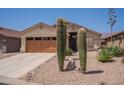 Single-story home featuring a desert landscape, a two-car garage, and a neutral color palette at 10346 E Desert Dawn Dr, Gold Canyon, AZ 85118