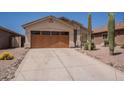 Single-story home featuring a desert landscape, a two-car garage, and a neutral color palette at 10346 E Desert Dawn Dr, Gold Canyon, AZ 85118