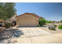 Inviting single-Gathering home featuring a two-car garage, desert landscaping, and a concrete driveway at 12441 W Windsor Blvd, Litchfield Park, AZ 85340