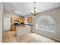 Eat-in kitchen features granite countertops, wood cabinets, and tile flooring with bright, natural lighting at 12441 W Windsor Blvd, Litchfield Park, AZ 85340