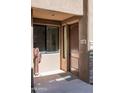 Close-up of front door with address number, showing modern design, next to desert landscaping at 13300 E Via Linda Dr # 1058, Scottsdale, AZ 85259