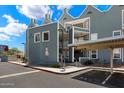 Charming condo featuring a carport, multiple balconies, and a blue-gray exterior paint at 1505 N Center St # 218, Mesa, AZ 85201