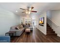 Bright living room features wood floors, a ceiling fan, and an open floor plan to the kitchen at 1505 N Center St # 218, Mesa, AZ 85201
