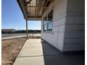 New home exterior under construction, featuring an open porch and modern architectural style at 15796 W Beryl Ave, Waddell, AZ 85355