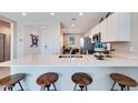Modern kitchen featuring stainless steel appliances, sleek countertops, and island seating at 16762 W Alameda Rd, Surprise, AZ 85387