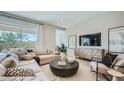 Bright living room with a sectional sofa, modern furniture, and large windows with lots of natural light at 16895 W Bronco Trl, Surprise, AZ 85387
