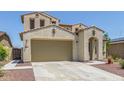 Beautiful two-story home boasting a spacious garage, beige stucco facade, desert landscaping, and a tile roof at 19022 W Shangri La Rd, Surprise, AZ 85388