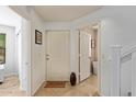 Bright entryway with tile flooring, white door, welcome mat, and access to other rooms at 2031 N 77Th Ln, Phoenix, AZ 85035