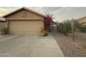 Charming home showcasing desert landscaping and a two-car garage at 2110 E Williams Dr, Phoenix, AZ 85024