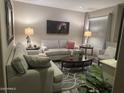 Cozy living room featuring plush seating, stylish decor, and ample natural light at 2110 E Williams Dr, Phoenix, AZ 85024