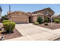 Well-maintained single-story home with a two-car garage and neatly landscaped front yard with desert landscaping at 2177 W Agrarian Hills Dr, San Tan Valley, AZ 85144