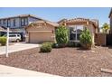Inviting single-story home with a well-kept front yard and a two-car garage, perfect for suburban living at 2177 W Agrarian Hills Dr, San Tan Valley, AZ 85144