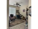 Comfortable home office with a ceiling fan and a large window providing natural light at 2461 W Muirfield Dr, Anthem, AZ 85086