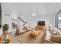 Bright living room with neutral tones, comfortable seating, and stairs leading to the second floor at 2812 E Clarendon Ave, Phoenix, AZ 85016