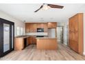 Bright kitchen featuring wood cabinetry, granite countertops, and an island at 2941 W Michigan Ave, Phoenix, AZ 85053