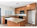 Well-lit kitchen showcasing granite counters, stainless steel appliances, and a center island at 2941 W Michigan Ave, Phoenix, AZ 85053
