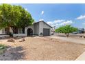 Attractive single-story home with desert landscaping, mature tree, and an attached garage at 3039 W Ross Ave, Phoenix, AZ 85027