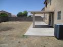 Large backyard featuring a covered patio and block wall, perfect for outdoor activities and privacy at 40504 N Las Praderas St, San Tan Valley, AZ 85140