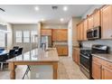 Bright kitchen features an island with granite countertops, stainless steel appliances, and tile flooring at 4630 E Navigator Ln, Phoenix, AZ 85050