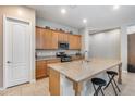 Large kitchen island with granite countertop seating provides ample workspace and a breakfast bar at 4630 E Navigator Ln, Phoenix, AZ 85050
