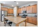 Spacious kitchen island with granite countertops and stainless steel appliances provides plenty of cooking space at 4630 E Navigator Ln, Phoenix, AZ 85050