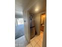 Hallway view of stainless steel refrigerator, bathroom, and the large living area at 4750 N Central Ave # 3S, Phoenix, AZ 85012