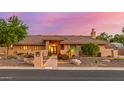 Beautiful single-story home featuring desert landscaping and a tile roof at dusk at 5861 E Anderson Dr, Scottsdale, AZ 85254