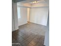 Bright bedroom featuring tile flooring, a window with blinds, and neutral walls for a serene living space at 5975 N 48Th Dr, Glendale, AZ 85301