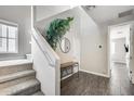 Welcoming foyer with staircase, decorative tree and decorative mirror provides a spacious entrance to the home at 631 W Winchester Dr, Chandler, AZ 85286