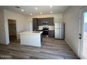 Stylish kitchen with stainless steel appliances, an island, and gray cabinets and countertops at 640 S Maricopa Rd, Florence, AZ 85132