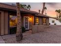 Inviting front entrance with a decorative screen door and warm exterior lighting at 6424 E Aire Libre Ln, Scottsdale, AZ 85254