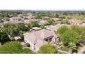 Expansive aerial view of several homes with backyard pools and lush landscaping at 6428 W Eugie Ave, Glendale, AZ 85304