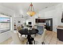 Dining area offering an open concept with views of the kitchen and living room at 719 W Milada Dr, Phoenix, AZ 85041