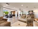 Open-concept living room featuring tile floors, neutral tones, plush seating, and access to the outdoor patio at 7510 E Larkspur Dr, Scottsdale, AZ 85260
