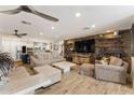 Inviting living room featuring stone accent wall, recessed lighting, tile floors, and comfortable seating at 7510 E Larkspur Dr, Scottsdale, AZ 85260