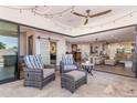 Outdoor patio featuring comfortable seating, an outdoor ceiling fan, and seamless access to the home's interior at 7510 E Larkspur Dr, Scottsdale, AZ 85260