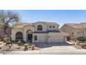 Charming two-story home with a three-car garage and a well-maintained desert landscape at 7527 E Nestling Way, Scottsdale, AZ 85255