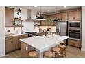 Modern kitchen featuring stainless steel appliances, a kitchen island, and pendant lighting over the island seating at 8000 W Griswold Rd, Peoria, AZ 85345