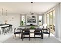 Bright, airy living room and dining area featuring modern furnishings, large windows, and sliding glass doors at 8024 W Griswold Rd, Peoria, AZ 85345