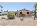 Attractive brick home featuring desert landscaping with gravel and mature shrubs at 8713 E Sage Dr, Scottsdale, AZ 85250