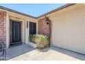 Inviting front entrance with a security door and attached two-car garage at 8713 E Sage Dr, Scottsdale, AZ 85250