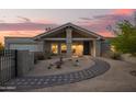 Inviting home with desert landscaping, a pathway to the front door, and a charming covered porch at 9432 E Quail Trl, Carefree, AZ 85377