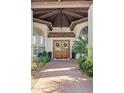 Elegant double front door with decorative wreaths under a covered entryway at 10205 E Corrine Dr, Scottsdale, AZ 85260