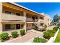 Charming condo featuring well-maintained landscaping, a staircase, and a desert landscape at 145 N 74Th St # 251, Mesa, AZ 85207